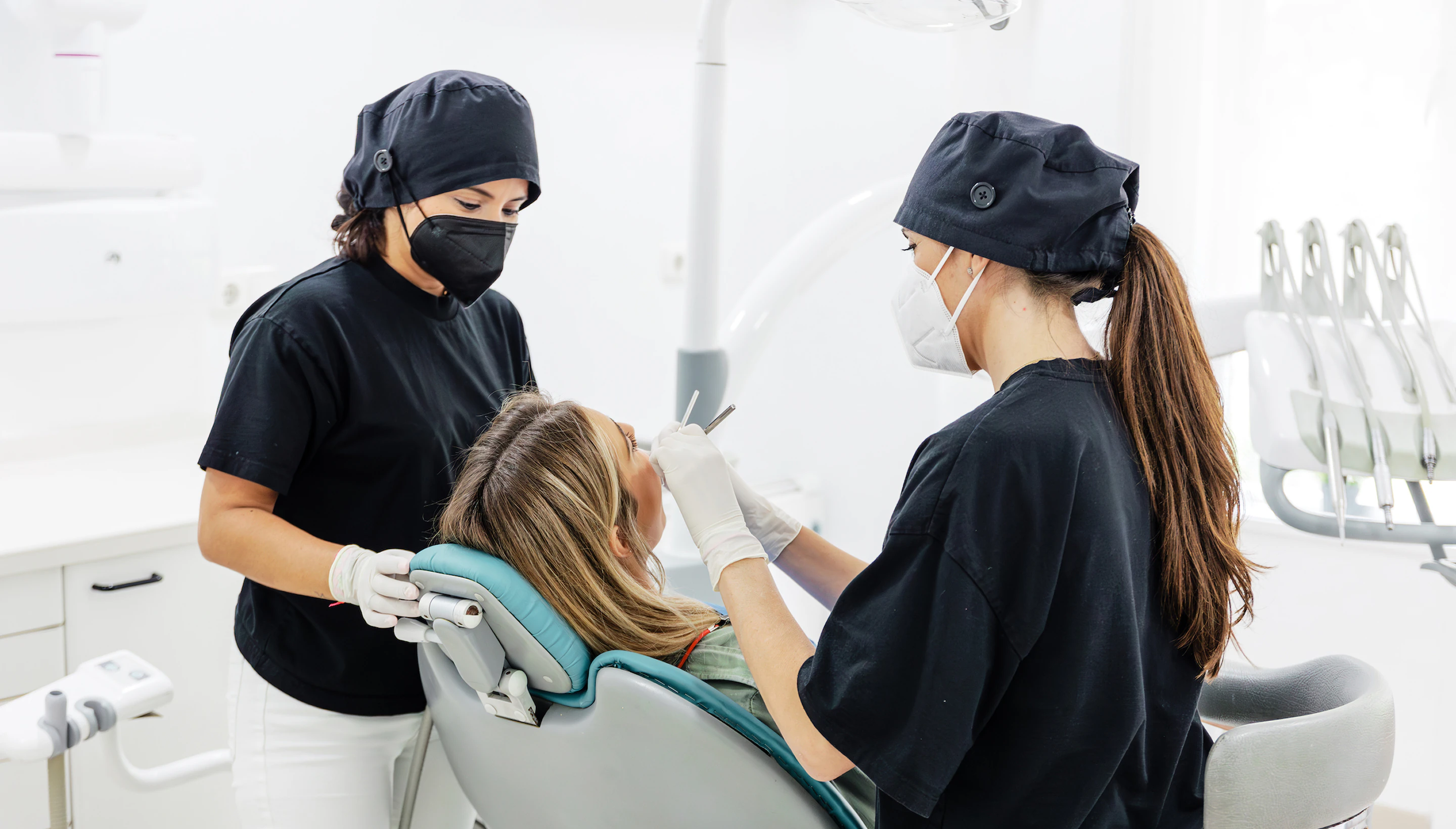 Two Fons Badal dentists treating a patient in the dental chair